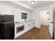 Modern kitchenette with stainless steel microwave, black refrigerator, and white cabinets and countertops at 308 Reed St, Scottdale, GA 30079