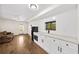 Bright kitchenette boasts white cabinets, sleek black appliances, and adjacent living area with neutral tones at 308 Reed St, Scottdale, GA 30079