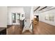 View of light-filled living room featuring hardwood floors, stylish staircase, and double glass doors at 308 Reed St, Scottdale, GA 30079