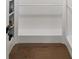 Walk-in closet with built-in shelving, wood floors, and clothing rod at 308 Reed St, Scottdale, GA 30079