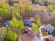 An aerial view of a home nestled among lush trees and verdant lawns at 4231 Carrington Ct, Douglasville, GA 30135