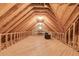 Spacious unfinished attic with wood beams, a wood floor, lighting and railings along the sides at 4231 Carrington Ct, Douglasville, GA 30135