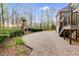 Brick patio with outdoor fireplace and stairs leading up to second level of home at 4231 Carrington Ct, Douglasville, GA 30135