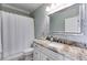 Bathroom with granite counters, large mirror and shower/tub combination with white shower curtain at 4231 Carrington Ct, Douglasville, GA 30135