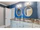 Elegant bathroom with double sinks, granite countertop, and stylish mirrors at 4231 Carrington Ct, Douglasville, GA 30135