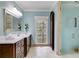 An updated bathroom with a marble countertop, framed mirror, and tiled floors at 4231 Carrington Ct, Douglasville, GA 30135
