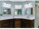 Bathroom with three mirrors, dark cabinets, and white countertops provides ample space at 4231 Carrington Ct, Douglasville, GA 30135