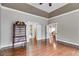 A bedroom with hardwood floors and crown molding allows entry to a bathroom at 4231 Carrington Ct, Douglasville, GA 30135