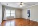 Spacious bedroom featuring hardwood floors, a ceiling fan, and natural lighting at 4231 Carrington Ct, Douglasville, GA 30135