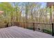 Spacious deck overlooks the private backyard, surrounded by mature trees and lush greenery at 4231 Carrington Ct, Douglasville, GA 30135