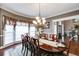 Spacious dining room with hardwood floors, elegant drapes, and a large window at 4231 Carrington Ct, Douglasville, GA 30135
