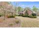 Well-maintained brick home with a curved driveway and mature landscaping at 4231 Carrington Ct, Douglasville, GA 30135