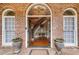 Elegant foyer with a curved staircase, hardwood floors, and leaded glass windows at 4231 Carrington Ct, Douglasville, GA 30135
