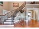 Elegant foyer with hardwood floors, a staircase, and a decorative glass table at 4231 Carrington Ct, Douglasville, GA 30135