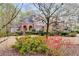 Charming brick home with arched entryway, blooming trees, and a manicured front lawn at 4231 Carrington Ct, Douglasville, GA 30135