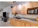Basement kitchenette features wood cabinets, light countertops and a microwave at 4231 Carrington Ct, Douglasville, GA 30135