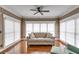 Comfortable seating arrangement in light-filled living room featuring hardwood floors and multiple windows at 4231 Carrington Ct, Douglasville, GA 30135