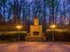 Inviting outdoor space with stone fireplace and manicured hedges, perfect for entertaining at 4231 Carrington Ct, Douglasville, GA 30135