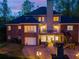 Rear view of the home featuring a deck, a patio, a garage, and outdoor lighting at 4231 Carrington Ct, Douglasville, GA 30135