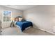 Neutral bedroom with a comfortable bed and a window with natural light at 6407 Barker Station Walk, Sugar Hill, GA 30518