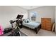 Cozy bedroom featuring a twin bed, dresser, and exercise equipment, perfect for a compact and functional space at 6407 Barker Station Walk, Sugar Hill, GA 30518
