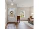 Bright foyer featuring hardwood floors, a decorative wreath, and a glimpse into the living areas at 6407 Barker Station Walk, Sugar Hill, GA 30518