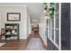 Inviting entryway featuring hardwood floors, decorative accents, and a view into the spacious living areas at 6407 Barker Station Walk, Sugar Hill, GA 30518