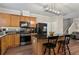 Well-equipped kitchen featuring wooden cabinets, black appliances, and a center island with bar stool seating at 6407 Barker Station Walk, Sugar Hill, GA 30518