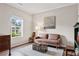 Cozy living room filled with natural light and featuring stylish furniture and hardwood floors at 6407 Barker Station Walk, Sugar Hill, GA 30518