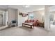 Cozy living room with a floral sofa, shelves, and large windows overlooking the backyard at 6407 Barker Station Walk, Sugar Hill, GA 30518