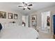 Spacious main bedroom with a ceiling fan, dressing mirror, and walk-in closet provides ample space and style at 6407 Barker Station Walk, Sugar Hill, GA 30518
