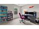 Bright home office with a well-organized desk, bookshelves, and natural light creates an ideal workspace at 6407 Barker Station Walk, Sugar Hill, GA 30518