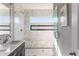 Bathroom features white marble tiled shower, glass shower door, and dark vanity at 1611 Flat Shoals Rd, Atlanta, GA 30316