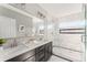 Elegant bathroom showcasing double sinks, a large mirror, and a luxurious glass-enclosed shower with marble tiles at 1611 Flat Shoals Rd, Atlanta, GA 30316