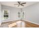 Bright bedroom featuring hardwood floors, a ceiling fan, and multiple windows offering natural light at 1611 Flat Shoals Rd, Atlanta, GA 30316