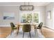 Dining room with an oval table, decorative rug, modern light fixture, and natural light at 1611 Flat Shoals Rd, Atlanta, GA 30316