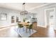 Open dining room features hardwood floors and a modern light fixture that connects to kitchen at 1611 Flat Shoals Rd, Atlanta, GA 30316