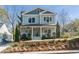 Inviting two-story home with a covered porch, landscaped front yard, and a charming curb appeal at 1611 Flat Shoals Rd, Atlanta, GA 30316