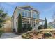 Charming two-story home with a welcoming front porch and well-manicured landscaping on a sunny day at 1611 Flat Shoals Rd, Atlanta, GA 30316