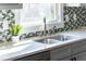 Close up on stainless sink and faucet with white countertop and bright window in kitchen at 1611 Flat Shoals Rd, Atlanta, GA 30316
