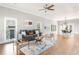 Spacious living room with hardwood floors, modern furniture, and ample natural light from large windows at 1611 Flat Shoals Rd, Atlanta, GA 30316