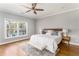 Spacious main bedroom with hardwood floors, natural light, and a decorative bench at 1611 Flat Shoals Rd, Atlanta, GA 30316