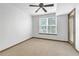 Bright bedroom features a ceiling fan and a large window with blinds for natural light at 390 17Th Nw St # 4048, Atlanta, GA 30363