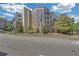 Contemporary condo building with neat landscaping, street view and a bright blue sky at 390 17Th Nw St # 4048, Atlanta, GA 30363
