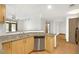 Open kitchen with stainless steel dishwasher, granite countertops, and hardwood floors at 390 17Th Nw St # 4048, Atlanta, GA 30363