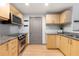 Galley style kitchen featuring stainless appliances, granite countertops, and ample storage at 390 17Th Nw St # 4048, Atlanta, GA 30363