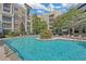 Sparkling swimming pool surrounded by lounge chairs and lush landscaping for relaxation at 390 17Th Nw St # 4048, Atlanta, GA 30363