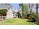 This spacious backyard with lush green grass is enclosed with a wooden fence for privacy and security at 430 Holly Stream Trl, Roswell, GA 30075