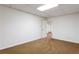 Finished basement with neutral carpet, painted walls, and an open doorway at 430 Holly Stream Trl, Roswell, GA 30075