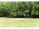 Community basketball court featuring two hoops and lush green surrounding trees offer a community recreational space at 430 Holly Stream Trl, Roswell, GA 30075